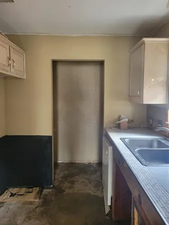 a room with cabinets and wooden floor