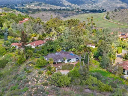 an aerial view of residential house with an outdoor space and seating