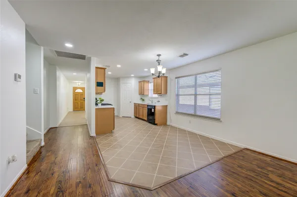 a view of a kitchen with furniture and wooden floor