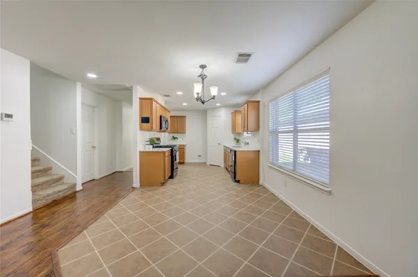 a open kitchen with sink and cabinets