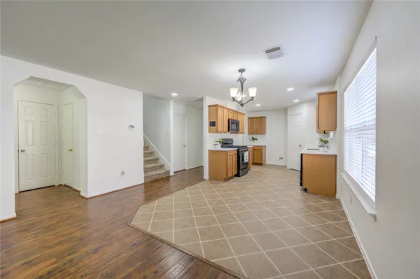 a open kitchen with cabinets and stainless steel appliances