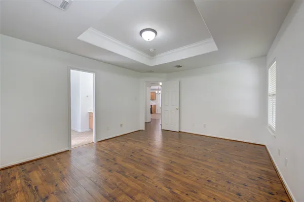 a view of an empty room and wooden floor