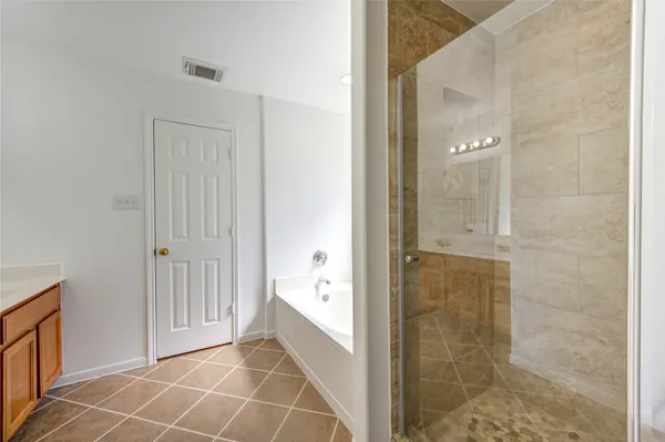 a bathroom with a bathtub and shower