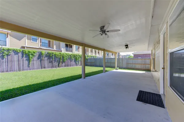 a view of a house with backyard and porch