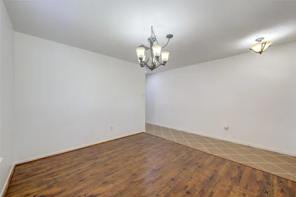 a view of a chandelier fan and wooden floor
