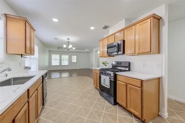 a kitchen with stainless steel appliances granite countertop a sink stove and cabinets