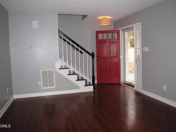 a view of an entryway with wooden floor