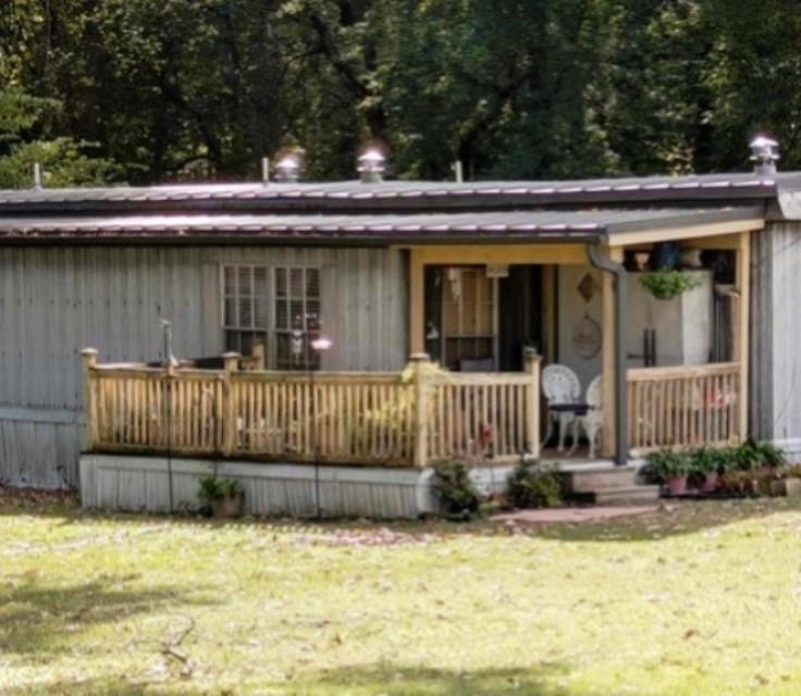 a view of a house with a wooden fence