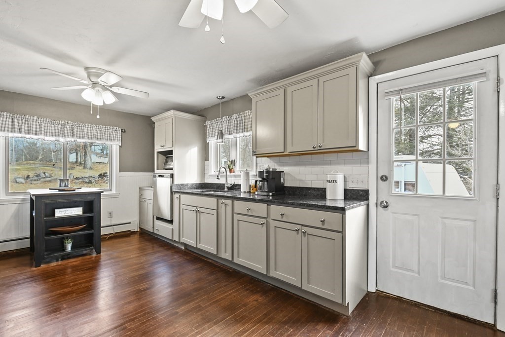 82 Stafford Road Holland, MA 01521 - Photo 6 of 18 a kitchen with stainless steel appliances granite countertop a stove top oven a refrigerator a sink and dishwasher with wooden floor