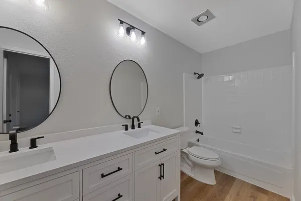 a bathroom with a toilet a sink and mirror