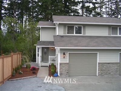 a front view of a house with garage