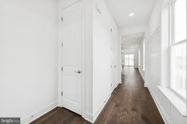 a view of a hallway with wooden floor