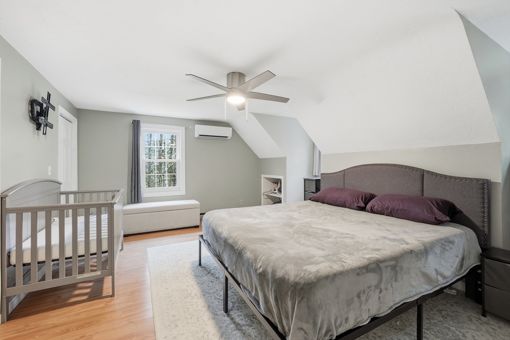 117 Draper Road East Brookfield, MA 01515 - Photo 13 of 27 a bedroom with a large bed and a chandelier