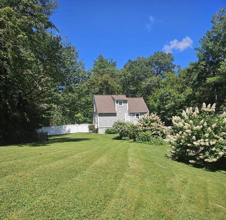 117 Draper Road East Brookfield, MA 01515 - Photo 22 of 27 a view of a garden with plants and large trees