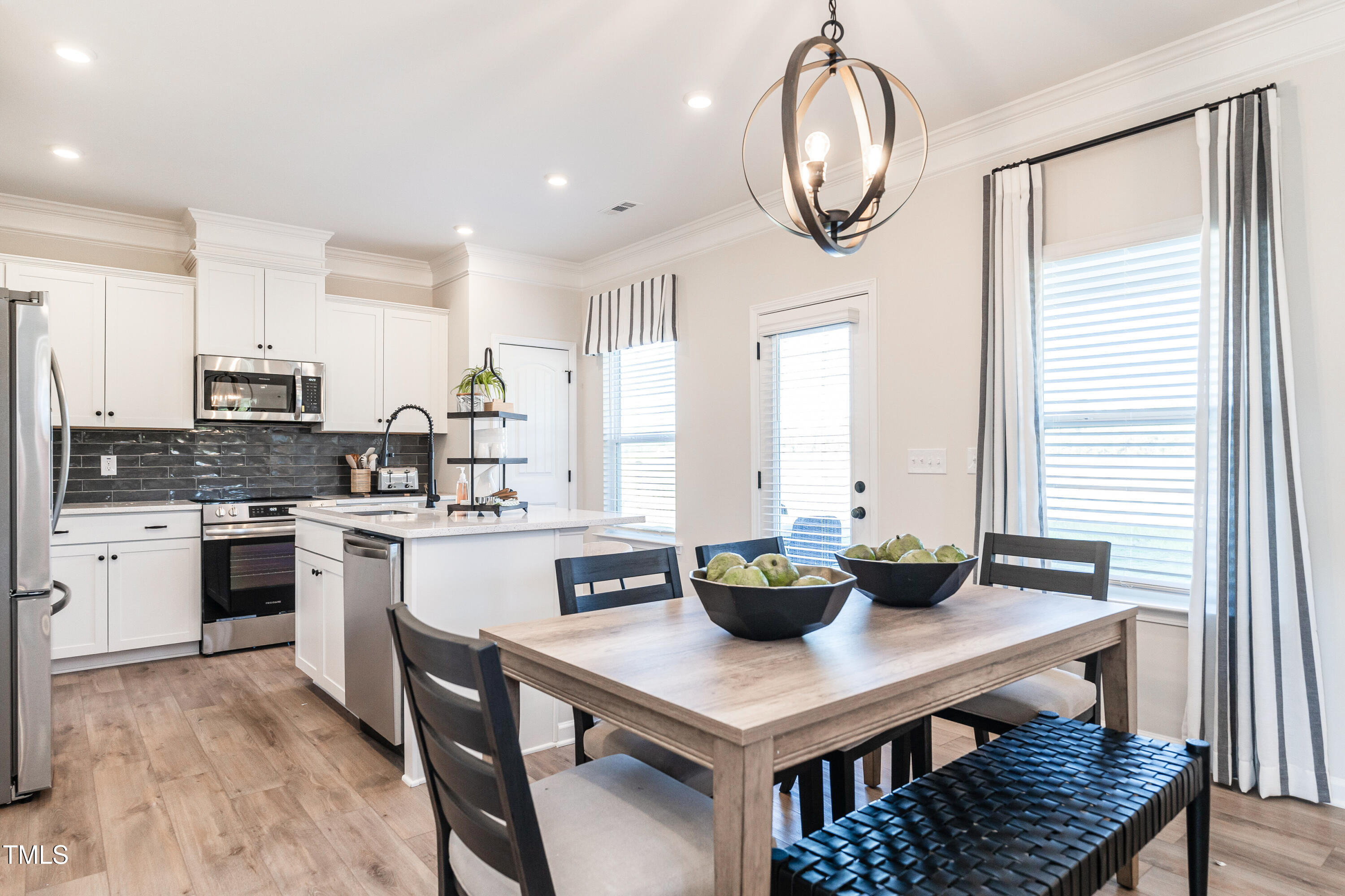 275 Deodora Lane Cameron, NC 28326 - Photo 11 of 38 a kitchen with stainless steel appliances a table chairs and a window