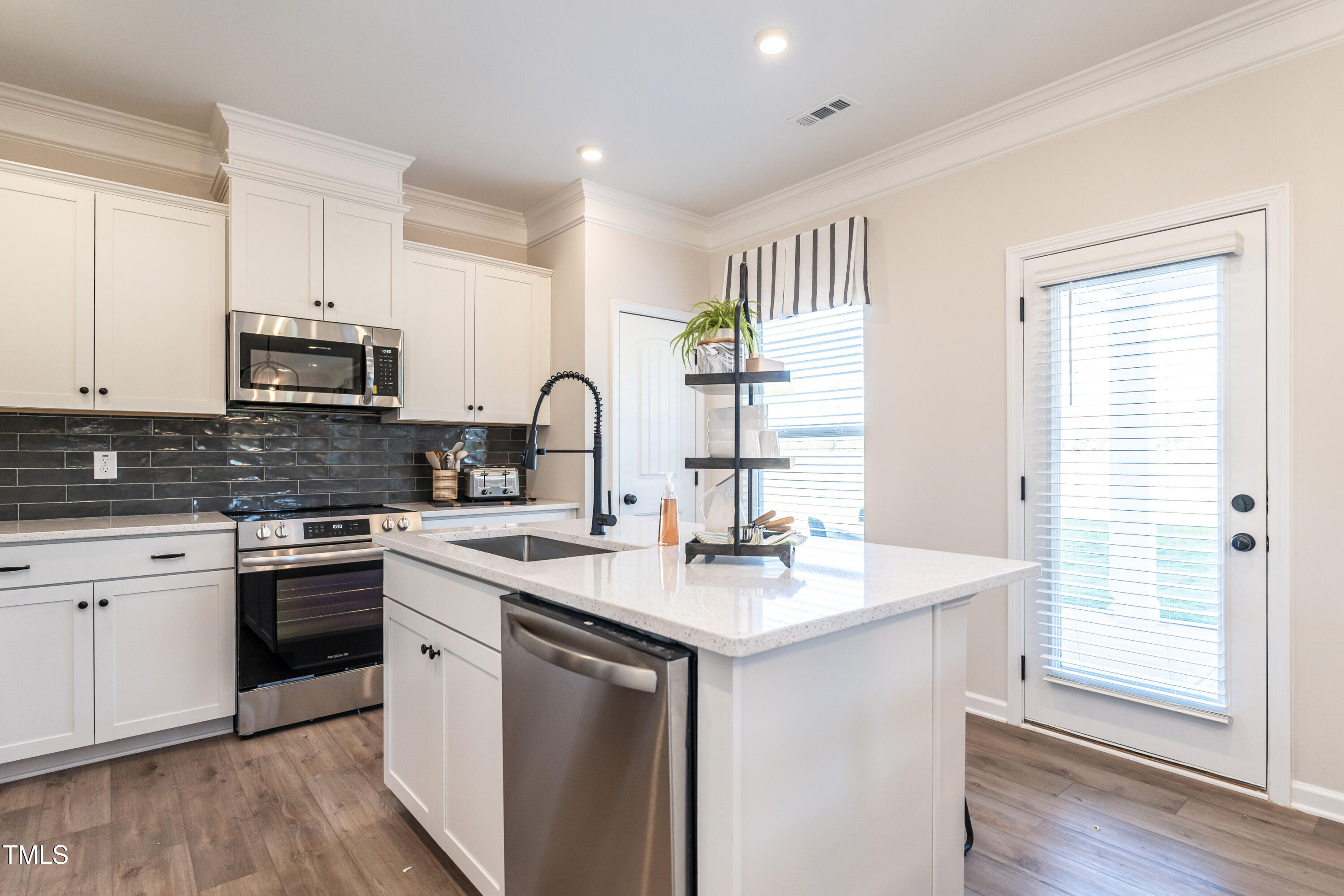 275 Deodora Lane Cameron, NC 28326 - Photo 14 of 38 a kitchen with stainless steel appliances granite countertop a sink stove cabinets and wooden floor