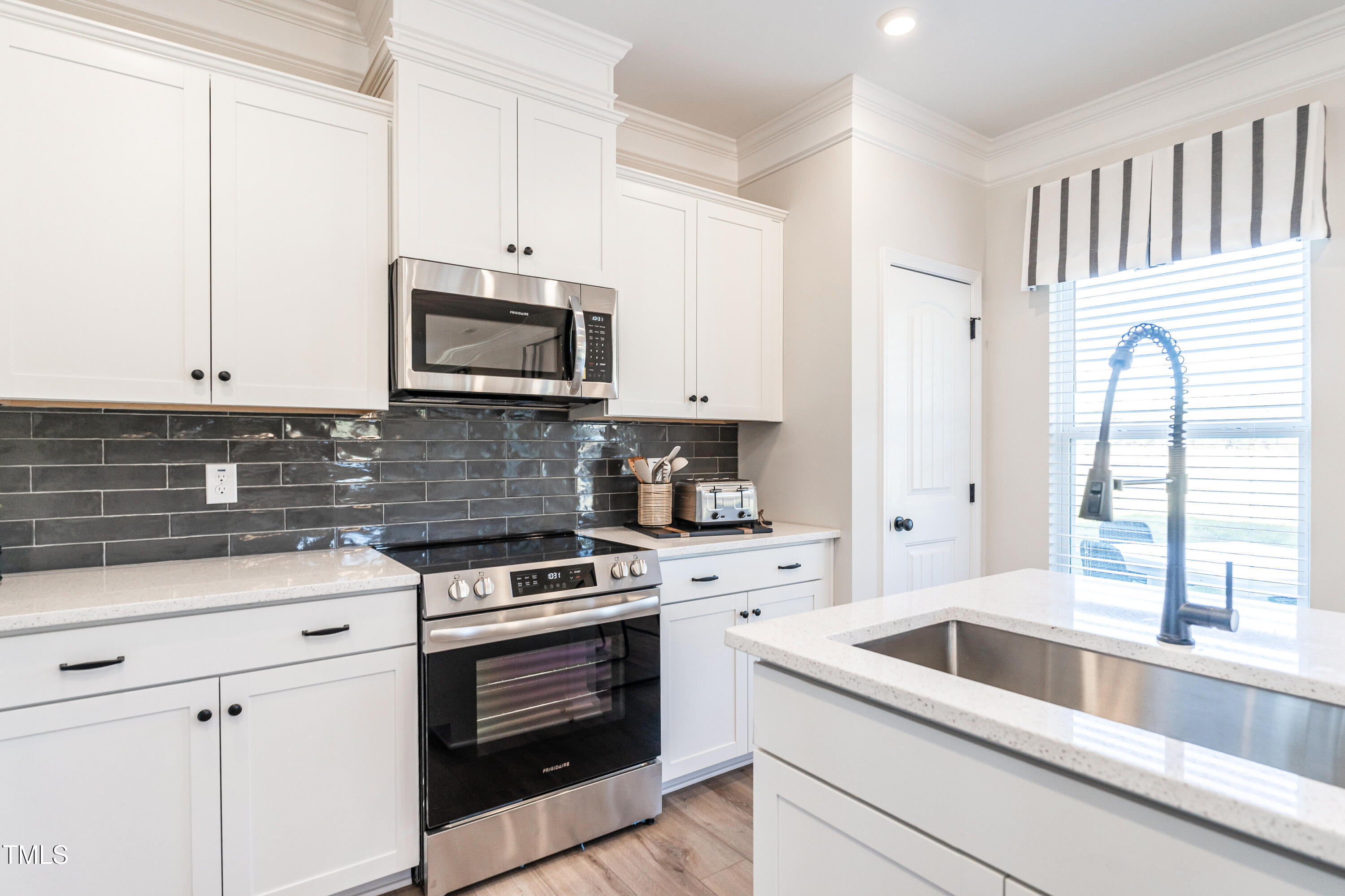 275 Deodora Lane Cameron, NC 28326 - Photo 20 of 38 a kitchen with granite countertop white cabinets and white appliances