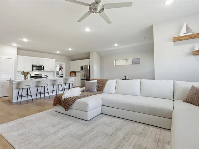 a living room with furniture and kitchen view