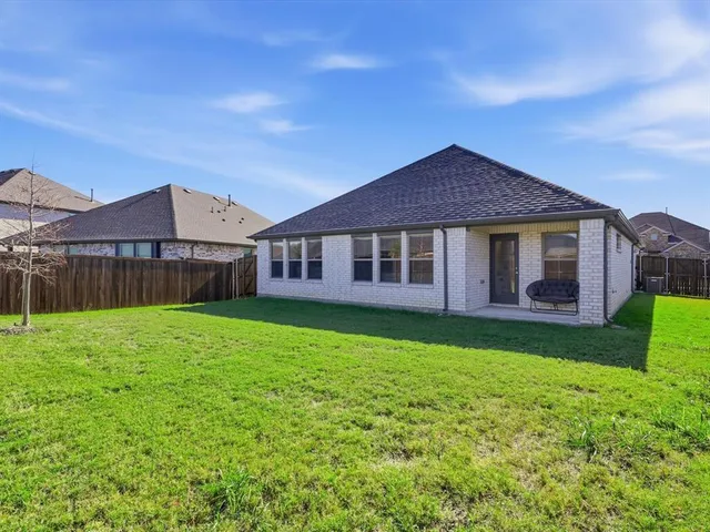 a view of a house with a yard and sitting area