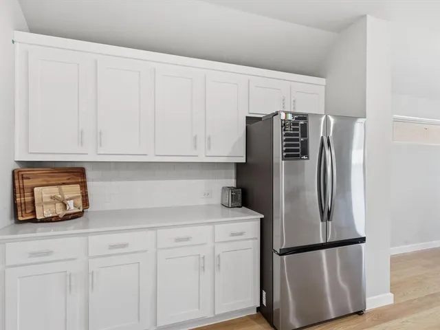 a kitchen with stainless steel appliances a refrigerator and cabinets