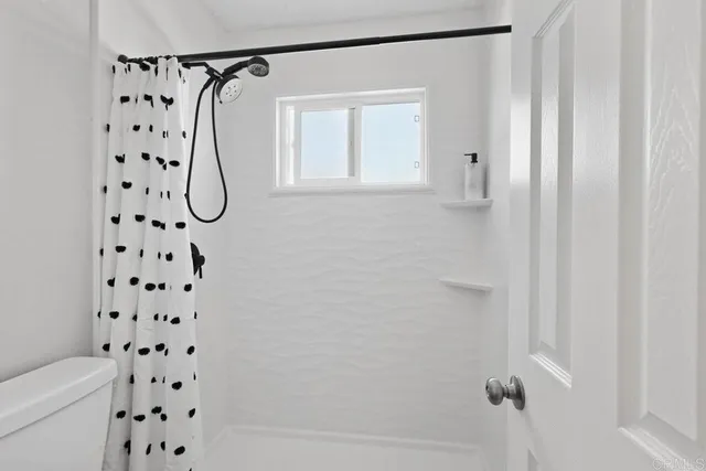 a view of walk in closet with clothes