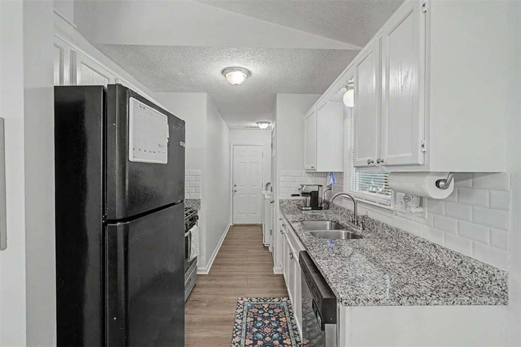 94 Villa Rosa Way Temple, GA 30179 - Photo 16 of 34 a kitchen with stainless steel appliances granite countertop a refrigerator and a sink