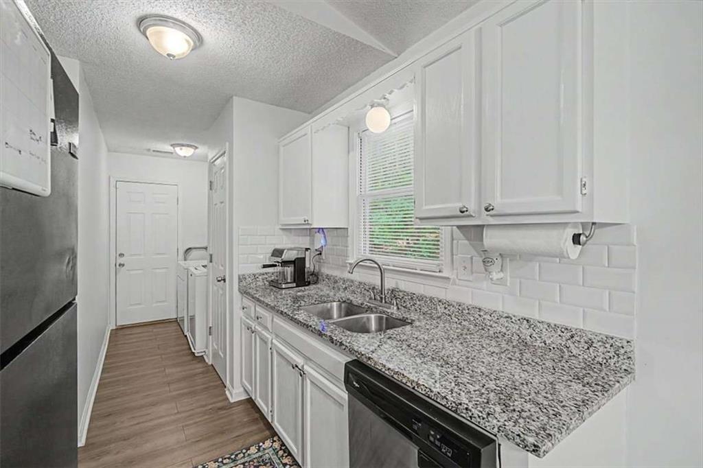 94 Villa Rosa Way Temple, GA 30179 - Photo 17 of 34 a kitchen with a sink stove and cabinets