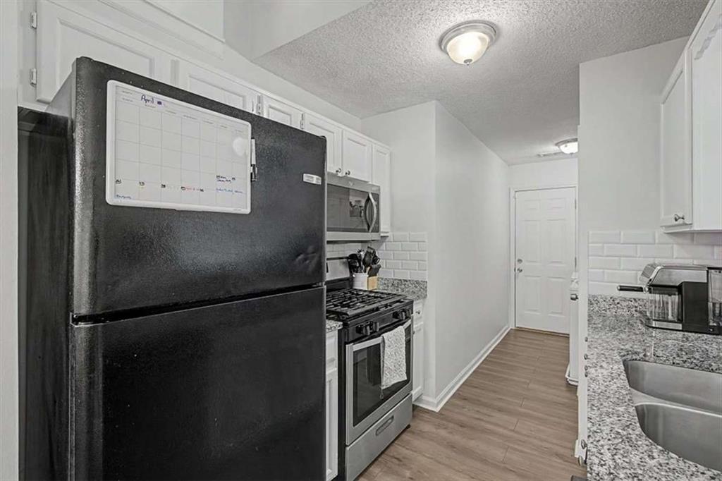 94 Villa Rosa Way Temple, GA 30179 - Photo 18 of 34 a kitchen with stainless steel appliances granite countertop a refrigerator and a stove