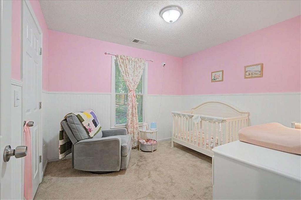 94 Villa Rosa Way Temple, GA 30179 - Photo 21 of 34 a living room with furniture and baby crib