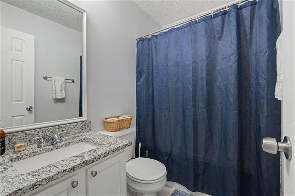 94 Villa Rosa Way Temple, GA 30179 - Photo 22 of 34 a bathroom with a granite countertop sink toilet and a mirror