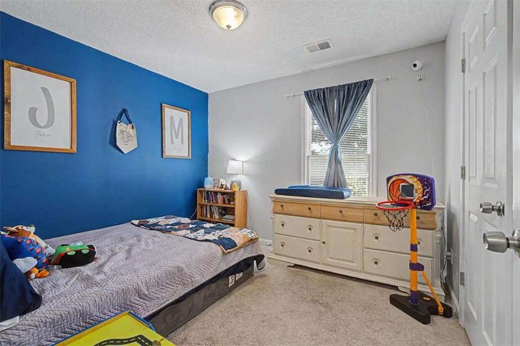 94 Villa Rosa Way Temple, GA 30179 - Photo 23 of 34 a bedroom with a bed and a dresser