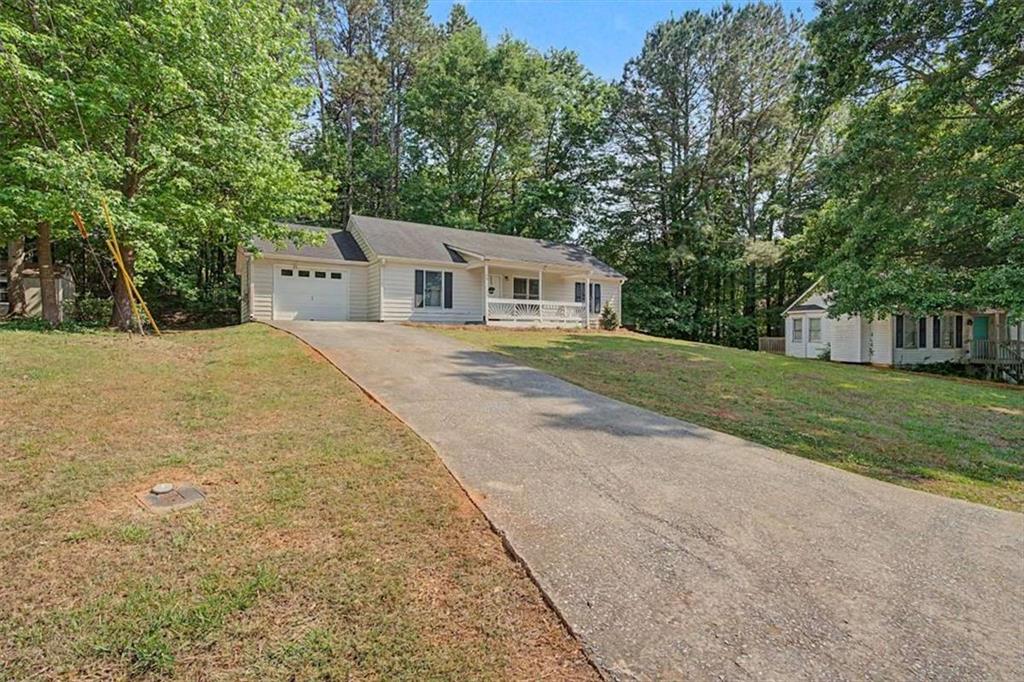 94 Villa Rosa Way Temple, GA 30179 - Photo 5 of 34 a front view of a house with a yard and trees