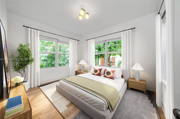 a bedroom with a bed and a large window with outer view