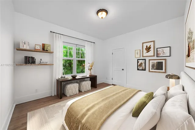 a bedroom with a bed and a large window