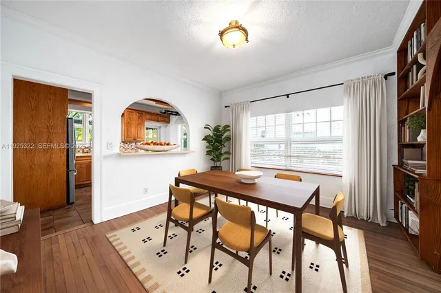 a view of a dining room with furniture and a window