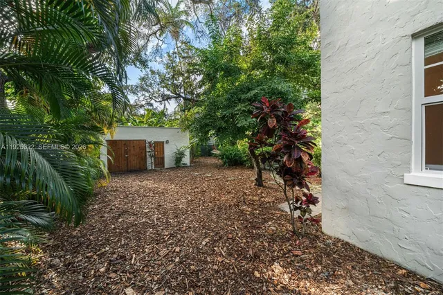 a view of a house with a yard and tree s