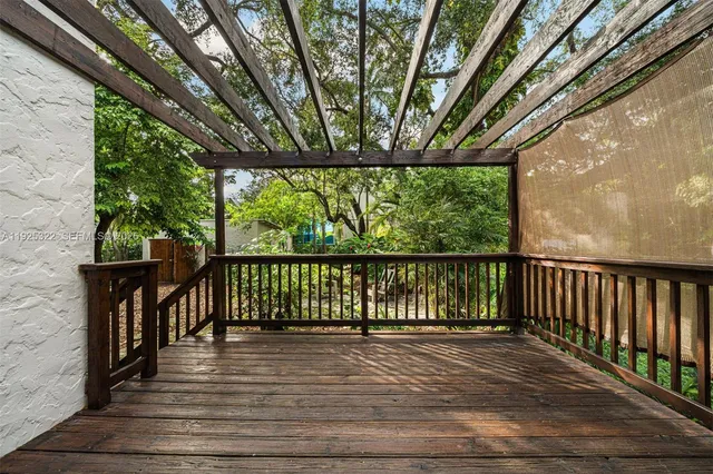 a balcony with wooden floor and outdoor space