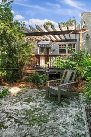 a view of a patio with table and chairs and potted plants