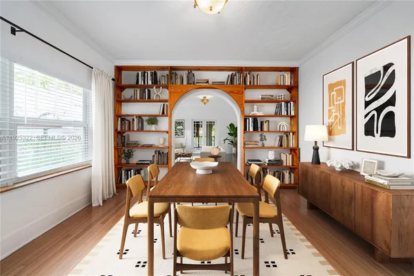 a view of a dining room with furniture and a window