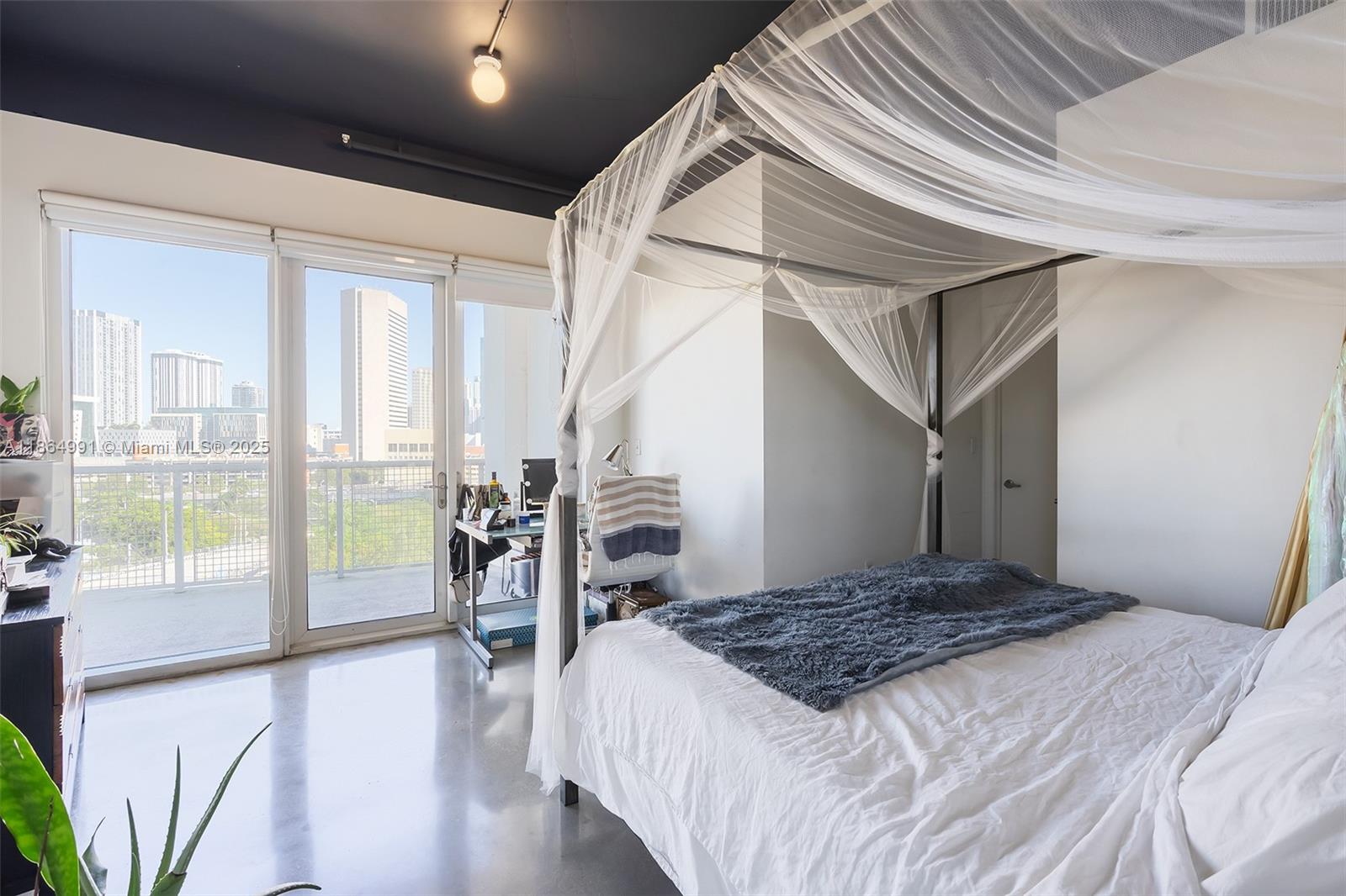 Riverside Miami, FL 33130 - Photo 8 of 20 a bedroom with a large bed and a large window with outer view