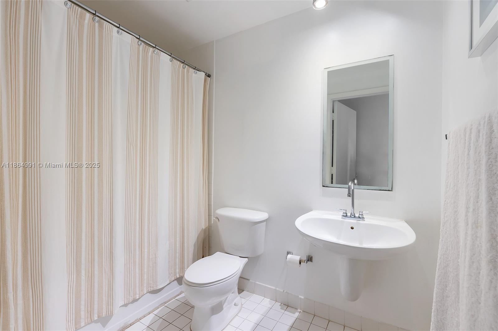 Riverside Miami, FL 33130 - Photo 9 of 20 a bathroom with a toilet sink and mirror