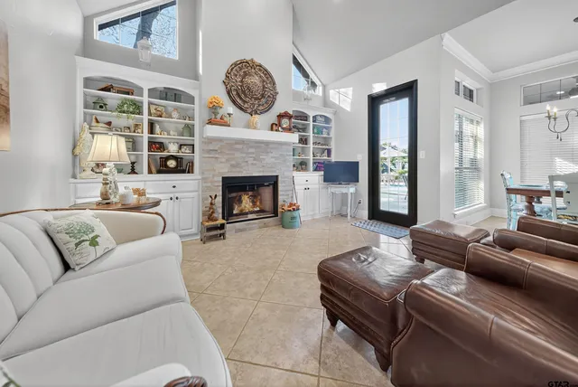 a living room with furniture a fireplace and window