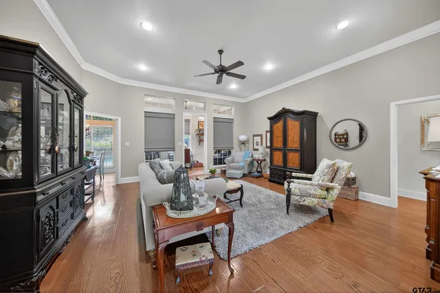 a living room with fireplace furniture and a wooden floor
