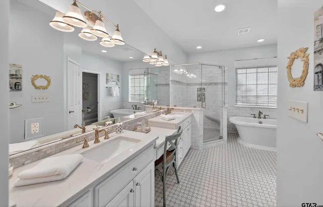 a large bathroom with a sink a large mirror and a toilet