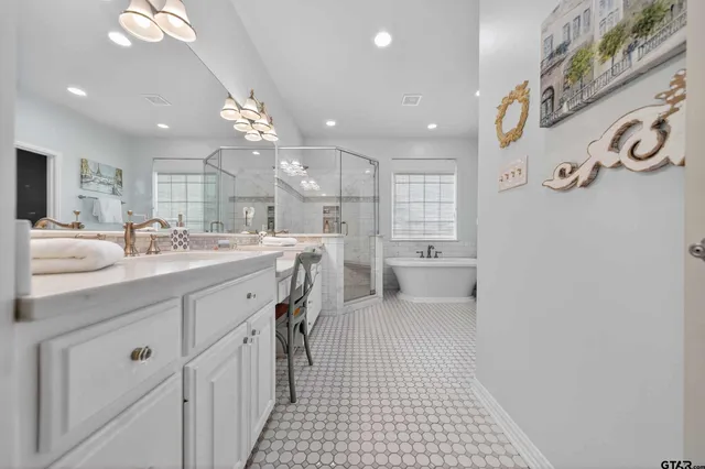 a bathroom with a sink a toilet a mirror and shower