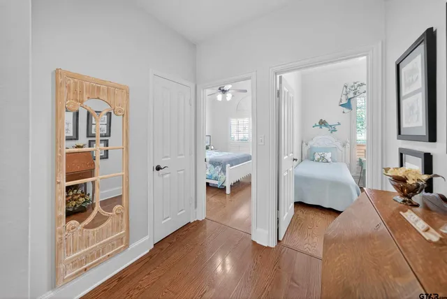 a en suite spacious bedroom with a bed and wooden floor