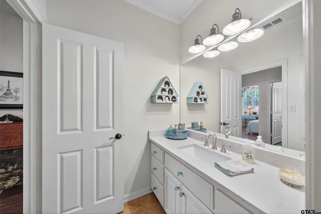 a bathroom with a double vanity sink and a mirror