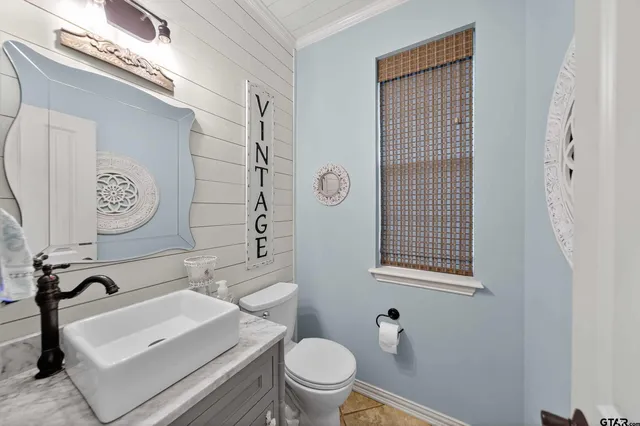 a white toilet sitting next to a bathroom sink