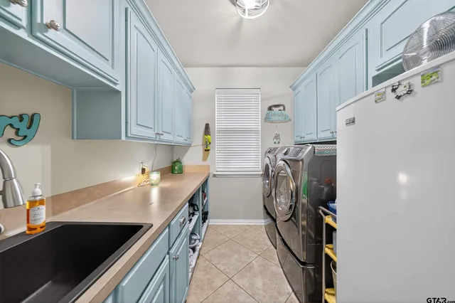 a kitchen with a refrigerator and a sink