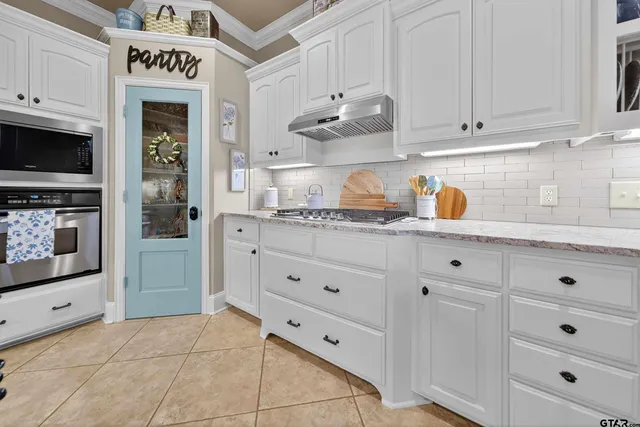 a kitchen with cabinets and window